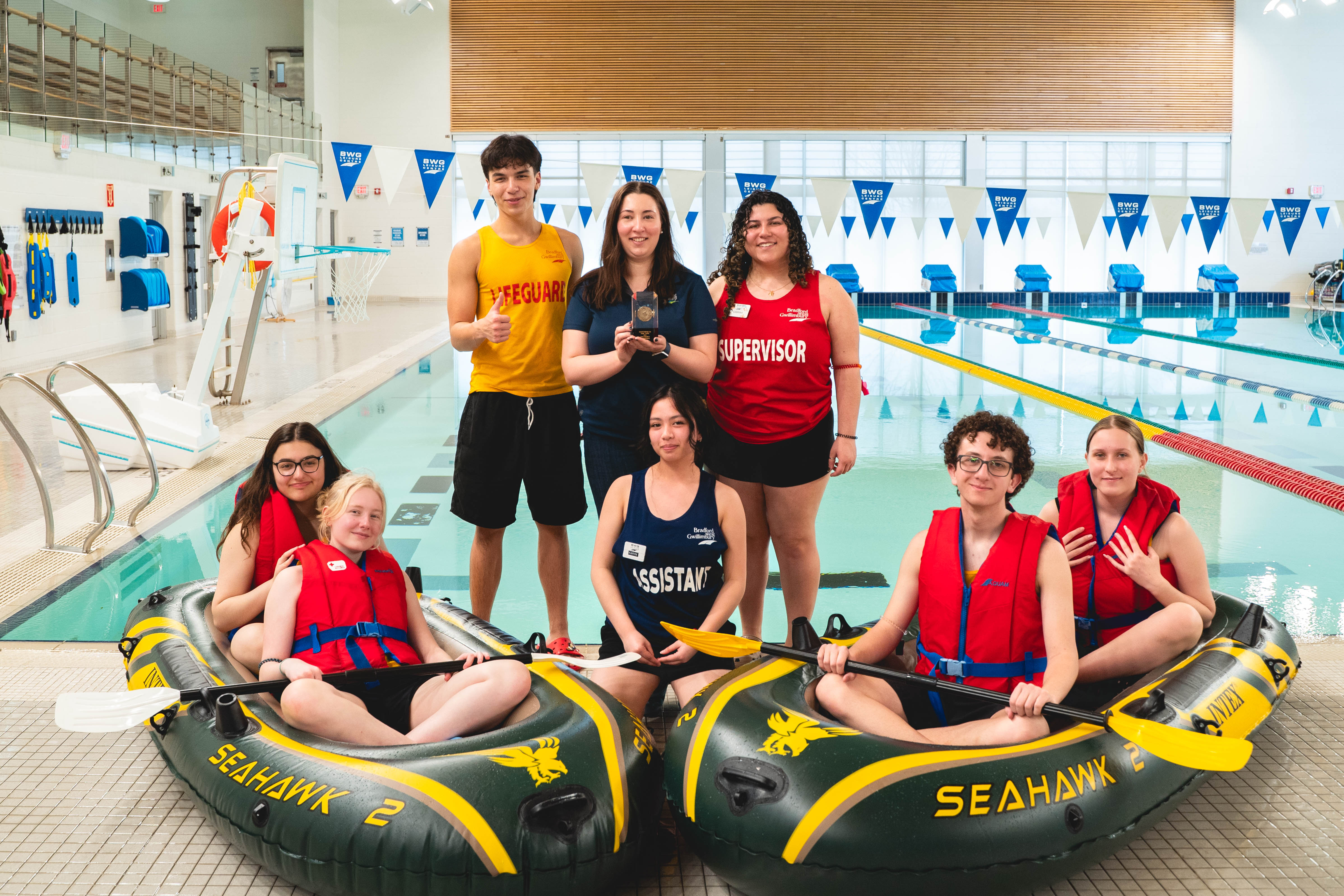 Group in front of pool with boats