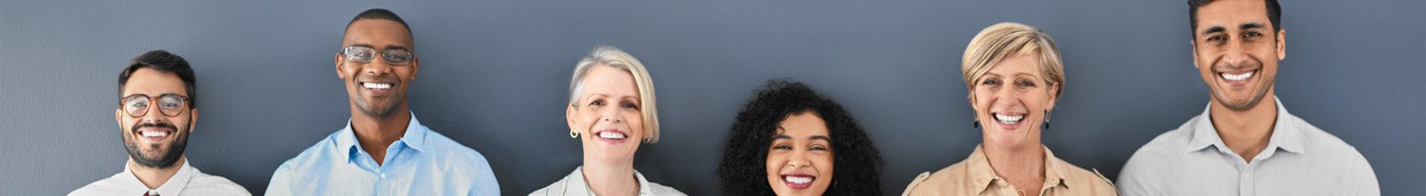 Group of people lined up against a grey background