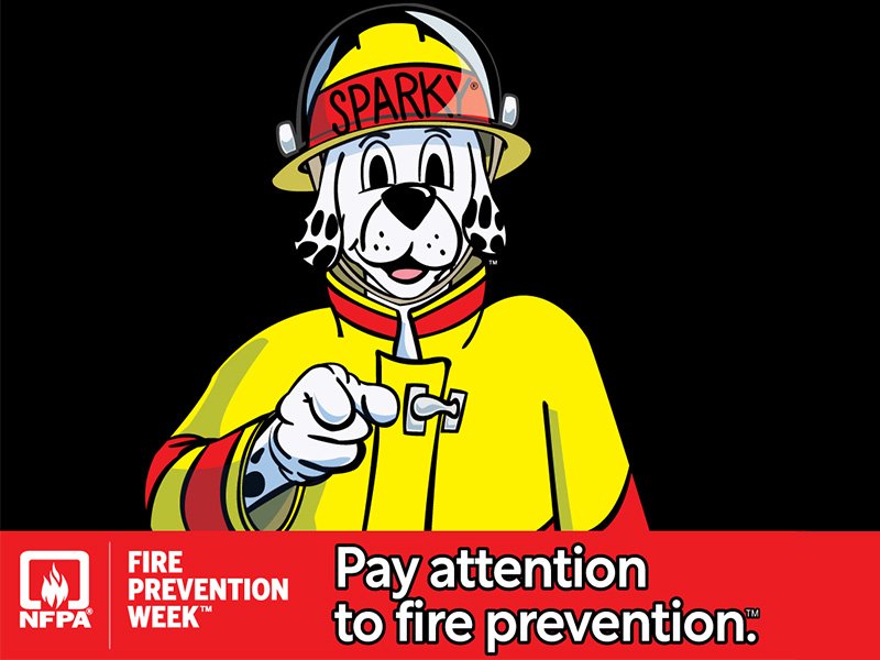 Sparky the dog pointing with the words pay attention to fire prevention