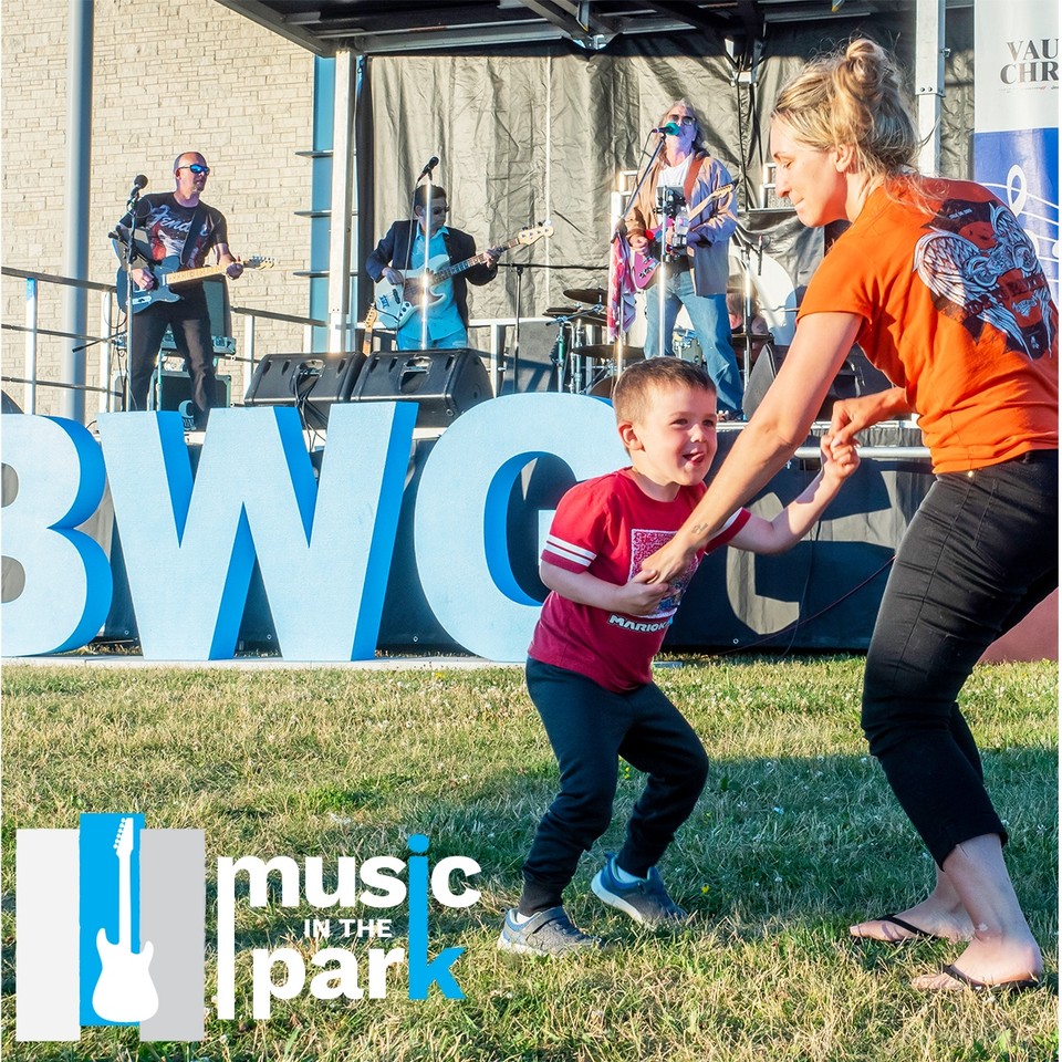 Image of stage at Music in the Park with mother and son dancing to music
