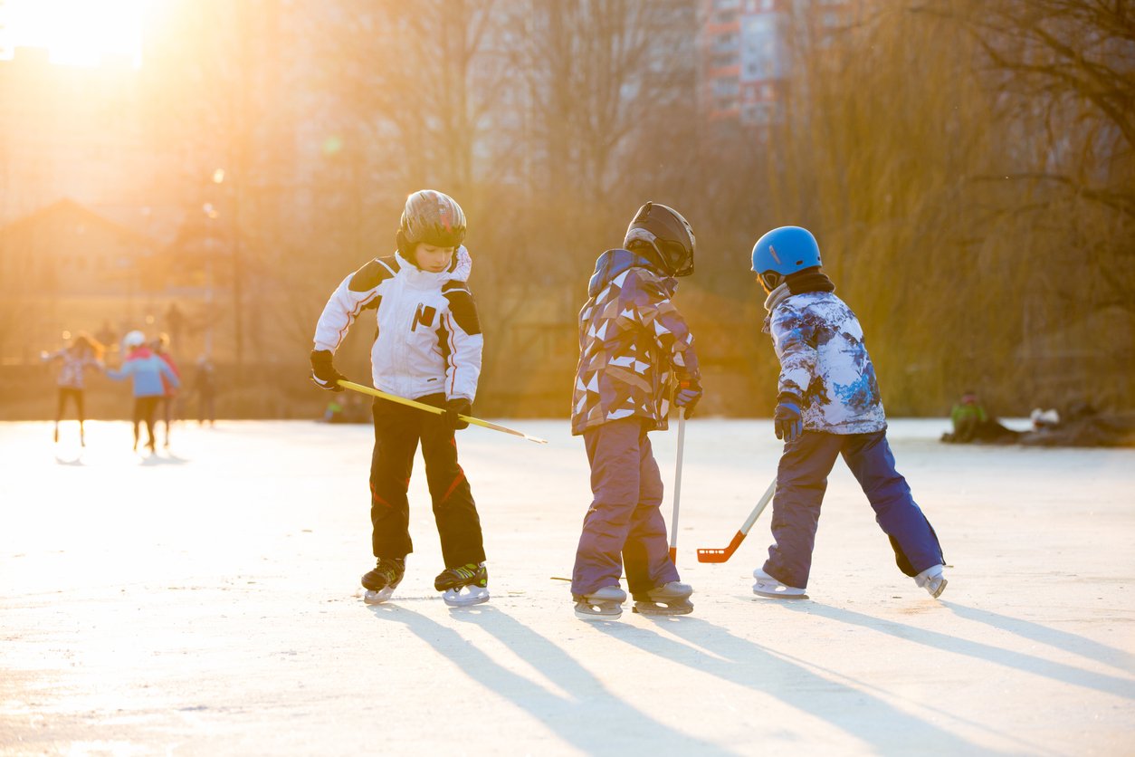 Image of kids playing hockey on an outdoor rink