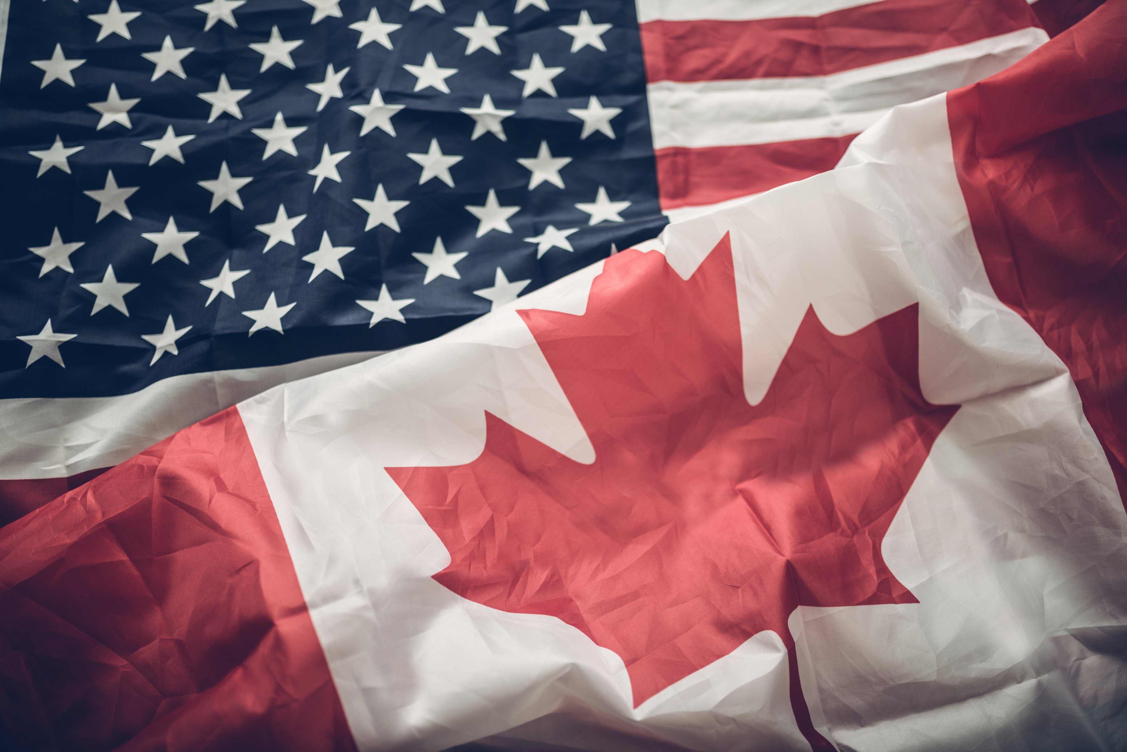 canadian flag and american flag laid out together