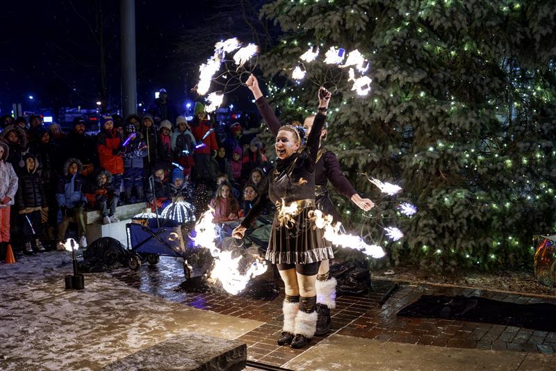 woman performing with fire with crowd looking on